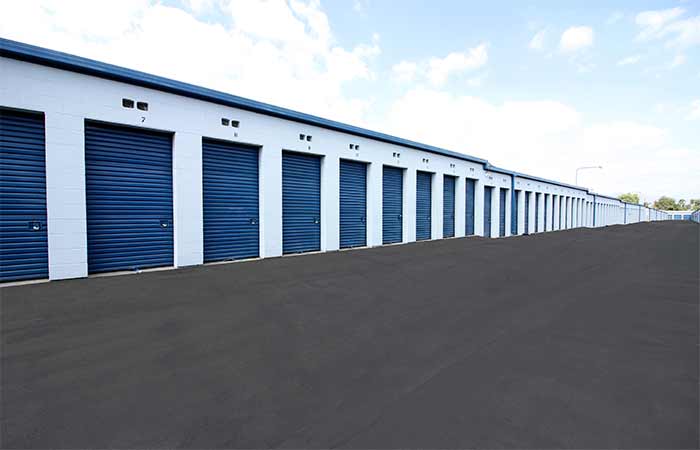 Small drive-up storage units with roll-up doors.