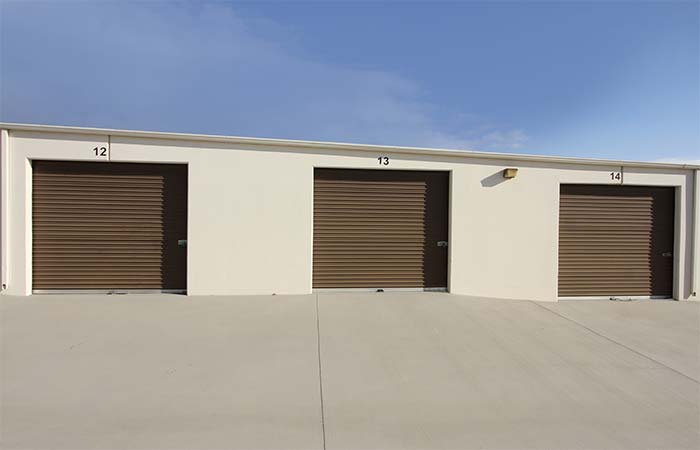 Large drive-up storage units with roll-up doors.