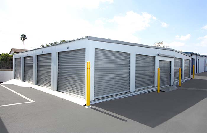 Drive-up storage units with easy access and roll-up doors.