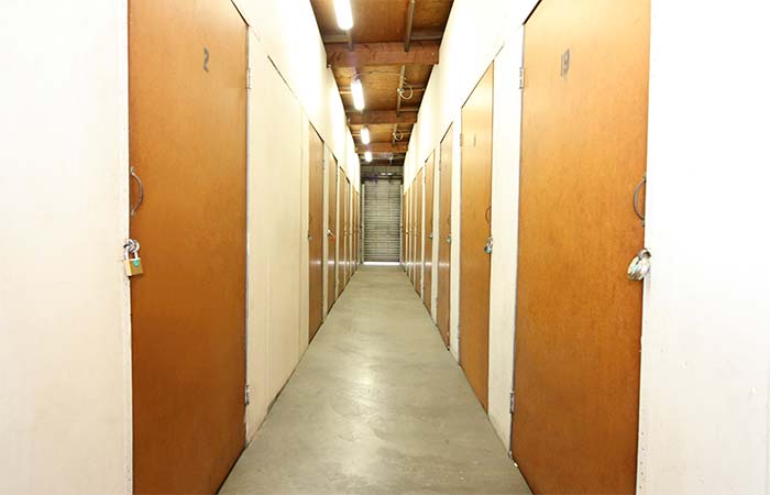 Indoor storage units in a well-lit hallway.